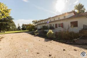 a house with a gravel driveway in front of it at Villa la sauzière in Buzet-sur-Tarn