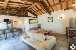 a living room with a couch and a table at La grande ferme in Ponlat-Taillebourg