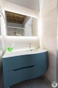 a bathroom with a blue sink and a mirror at La grande ferme in Ponlat-Taillebourg +43 photos