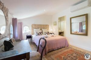 a bedroom with a bed with stuffed animals on it at Villa la sauzière in Buzet-sur-Tarn +61 photos