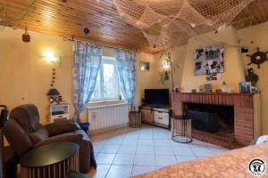a living room with a couch and a fireplace at Comà a l'ostal in Montégut-Lauragais