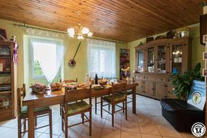 a dining room with a wooden table and chairs at Comà a l'ostal in Montégut-Lauragais