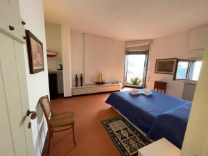 a bedroom with a blue bed and a window at Villa a Rocchetta Luxury Guesthouse in Monterosso al Mare