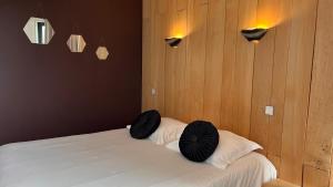 a bedroom with a bed with two pillows on it at Fasthotel L'Eldorado in Sébazac-Concourès +68 photos
