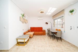 a living room with a couch and a table at 4-Bed Villa Sleeps 8 Pets Ok & 10 min to Beach in Los Alcázares
