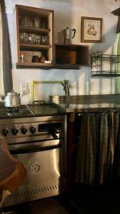 a kitchen with a stove and a counter top at Casitas del arroyo Actividades Arte Cultura y descanso en Villa General Belgrano in Villa General Belgrano