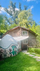 a house with a painting on the side of it at Casitas del arroyo Actividades Arte Cultura y descanso en Villa General Belgrano in Villa General Belgrano