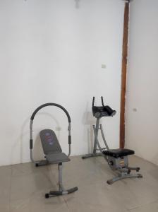 a room with two exercise bikes and a treadmill at Family house rental in Puerto López +4 photos
