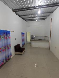 a waiting room with a chair and a table at Family house rental in Puerto López