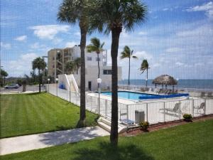 a view of a swimming pool and the beach at Beachfront Condo on Coco Plum Beach in Marathon