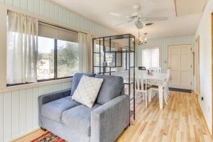 a living room with a chair and a table at Walk to Shore Outer Banks Beach Bungalow in Kill Devil Hills