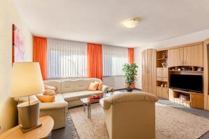 a living room with a couch and a tv at Riedel Fronz in Lennestadt