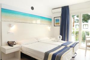Postel nebo postele na pokoji v ubytování Hotel Cassandra