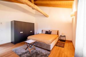 a bedroom with a large bed in a room at Homeby, Villa Corte dello Zanchino in Zola Predosa