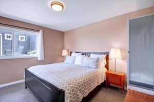 a bedroom with a large bed and a window at 11 Lower Terrace by Catalina Island Vacations in Avalon
