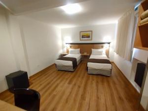 Cama ou camas em um quarto em Argentino Hotel