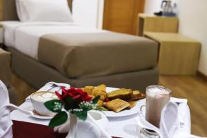 a table with a plate of food and a bed at Delmar Hotel Matrouh in Marsa Matruh