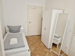 a small room with a bed and a mirror at New City Center Stays 2 in Munich +118 photos