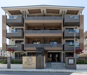 an apartment building with balconies on a street at Nerium Apartments Leptokaria in Leptokarya