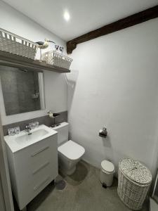 a white bathroom with a toilet and a sink at HappyVila SUITE APARTMENTS in Villajoyosa