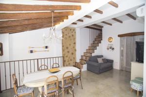 a dining room with a table and chairs and a couch at HappyVila SUITE APARTMENTS in Villajoyosa