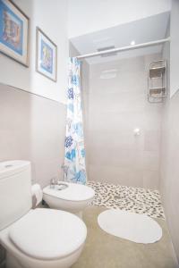 a white bathroom with a toilet and a shower at HappyVila SUITE APARTMENTS in Villajoyosa +37 photos