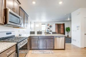 a kitchen with a stove and a microwave at 17 Mi to Denver Zoo Family-Friendly Aurora Home in Aurora