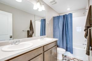 a bathroom with a sink and a toilet and a mirror at 17 Mi to Denver Zoo Family-Friendly Aurora Home in Aurora +18 photos