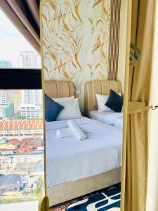 a mirror reflecting a bed in a hotel room at Jac Urban Suites Luxury & Premium Staycation 10pax in George Town