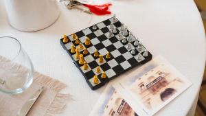 a chess board on a table with a bottle of wine at Palazzo Zacà in Gallipoli