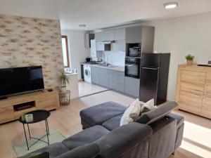 a living room with a couch and a kitchen at Garden House in Roudnice nad Labem