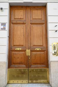 a pair of wooden doors on a building at Magnoliahome Suites at the Vatican in Rome