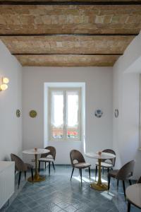 a room with tables and chairs and a window at Magnoliahome Suites at the Vatican in Rome +51 photos