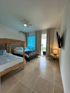a bedroom with two bunk beds and a window at Villas del Mar PTY in Río Hato +43 photos