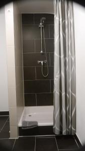 a bathroom with a shower with a shower curtain at Ferienwohnung "HeX N-STuBe" in Weißenburg in Bayern