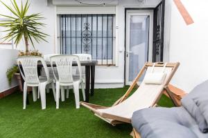 a patio with green grass and a table and chairs at Seahomes Vacations - Center Apt Tossa de Mar in Tossa de Mar
