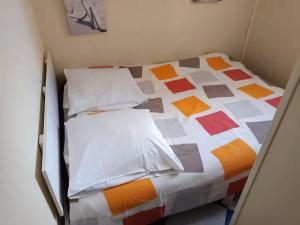 a bedroom with a bed with a colorful quilt at Casa Marina - Le Petit Bleu Vue mer in Pornic