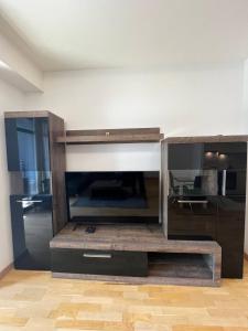 a living room with a large entertainment center at BW St Lui Apartment in Belgrade