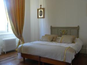 a bedroom with a bed with a cross on the wall at Villa Boulmia in Burlats