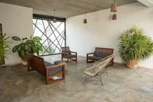 a room with chairs and a table and plants at Casa Diego Unique Ecological / Minimalist House & Inside Pool in Brisas de Zicatela