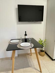 a table with two glasses and a bottle of wine at Kos Physis Apartment in Kos Town +22 photos
