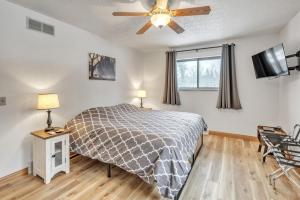 a bedroom with a bed and a ceiling fan at Boulder Junction Motor Lodge in Boulder Junction