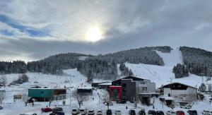 a ski resort in the snow with a mountain at Pied des Pistes in Métabief