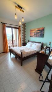 a bedroom with a large bed and a table at Colle al mare 34 - rooms & bike - affittacamere in Porto Recanati
