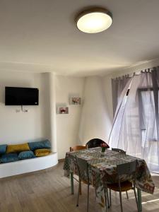 a living room with a table and a couch at BM Flowers in Tropea