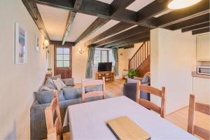 a living room with a couch and a table at Host & Stay - Providence Cottage in Woolacombe +12 photos