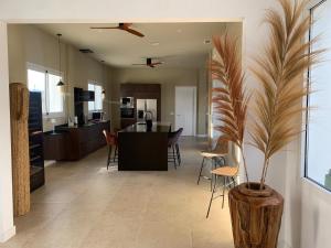 a kitchen and living room with a vase with a plant at El Olivo Private Swimming Pool in Mojácar