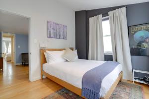 a bedroom with a bed and a large window at Sojourn Only 8 Blocks to Capitol with Private Patios in Washington