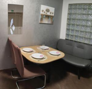 a dining room table and chairs with plates and wine glasses at Apartment Anita in Fažana +18 photos
