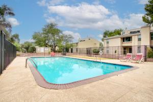 a swimming pool in front of a building at Pet-Friendly Tucson Townhome with Pool Access! in Tucson